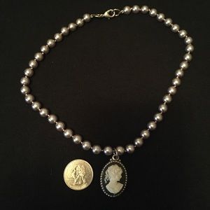 Cameo with grey pearl necklace.